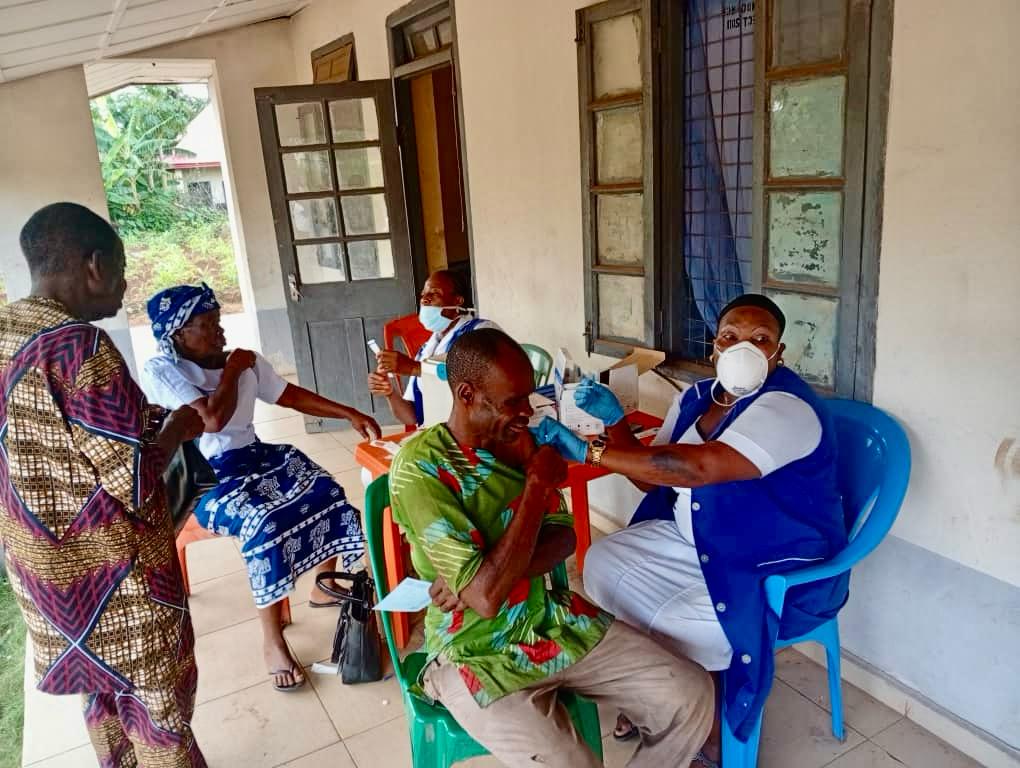 health care worker administering vaccines to adults